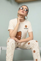My Store off-white jersey knit 2-piece pajama set with bear and cookie print. Round neck top and wide-leg pants.