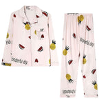 My Store Women's light pink pajama set with pineapple, watermelon, and heart print. Button-down top and elastic waist pants.